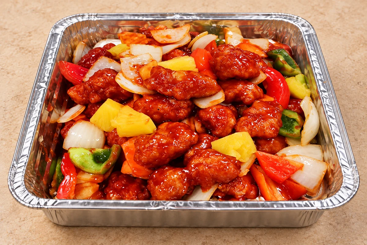 Dumpling Chef sweet and sour chicken with vegetables in a catering tray