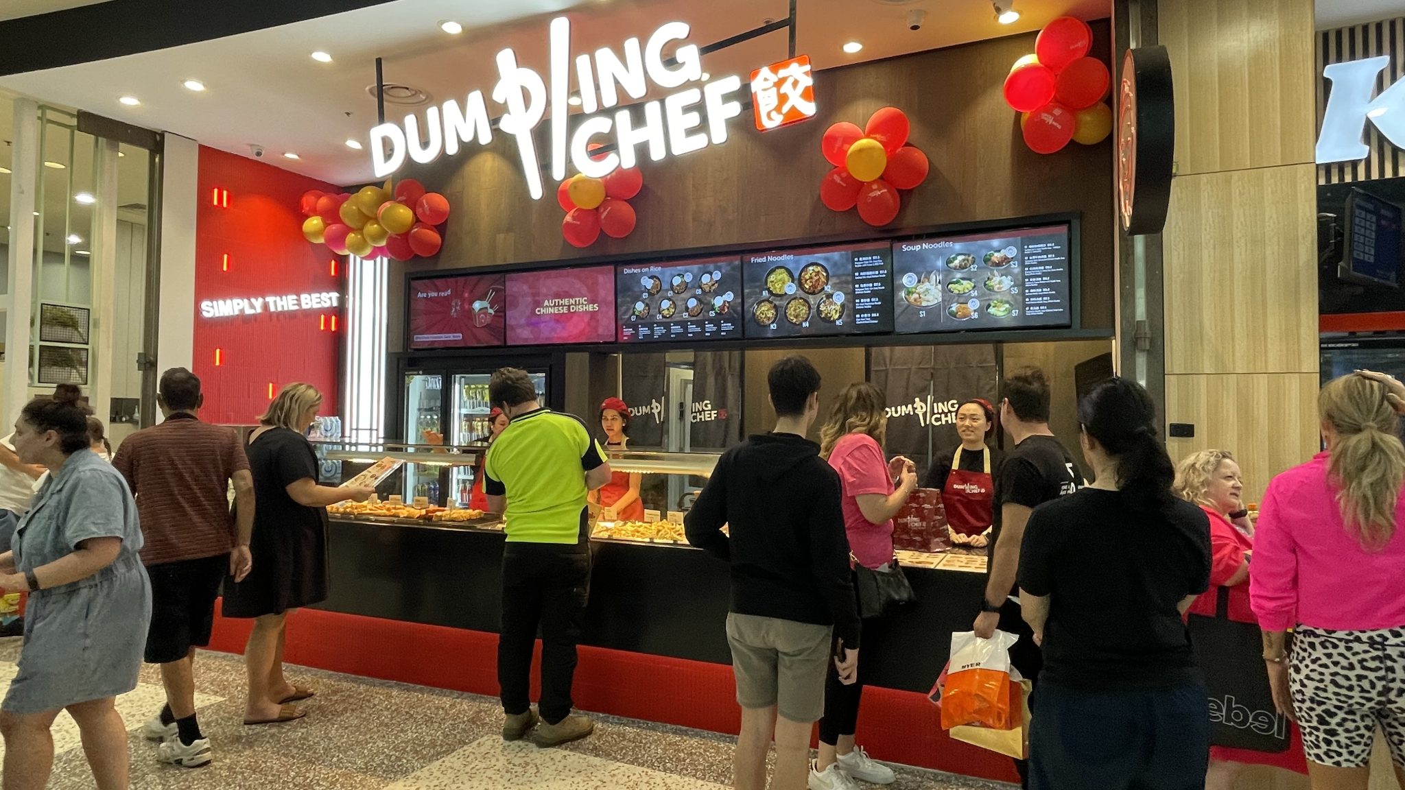 Customers at the Dumpling Chef store counter
